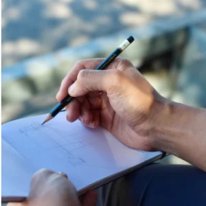 a person holding a pen and notebook